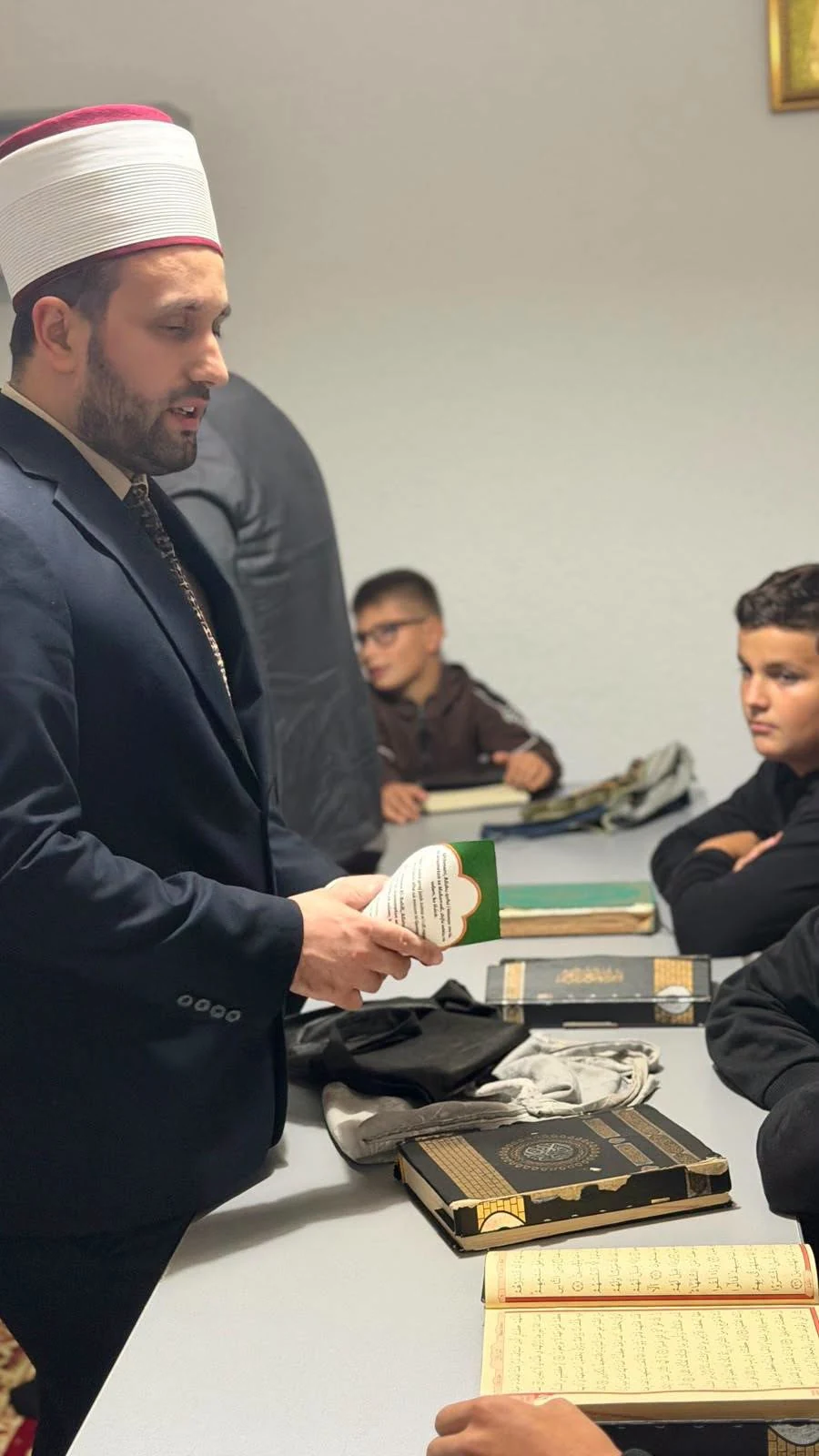 Students at the New Mosque in Pallçisht i Poshtëm pass their Qur’an examination